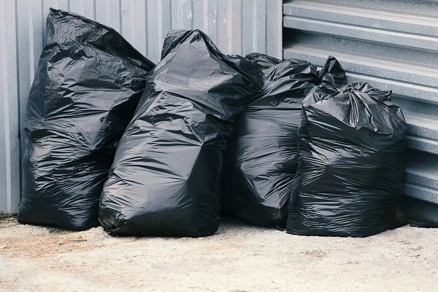 Contractor Bags displayed against exterior metal wall of building